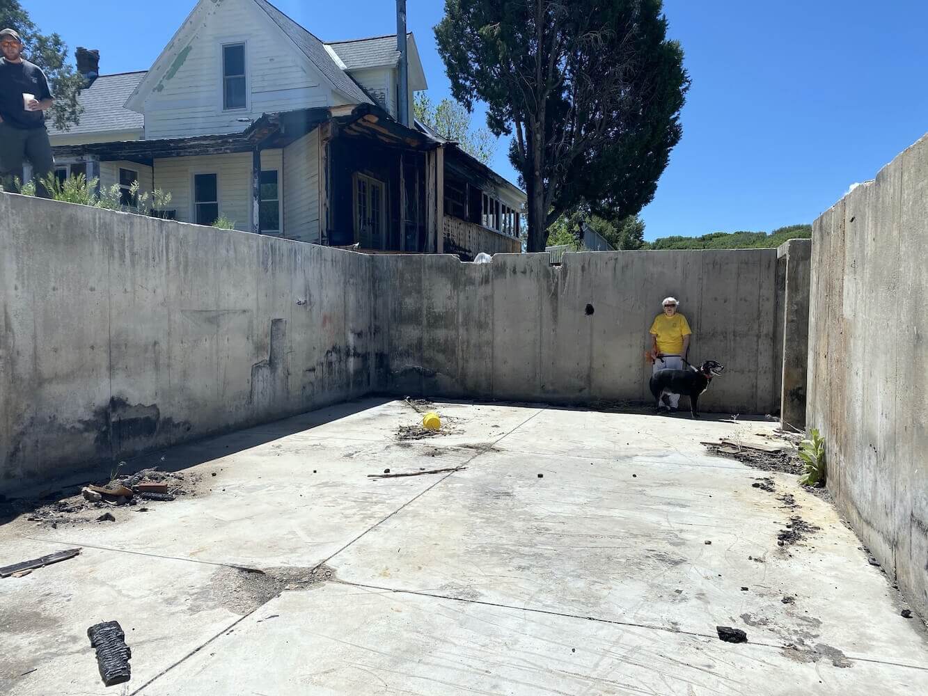 A burnt down house becomes a natural heat sink for a new home & greenhouse