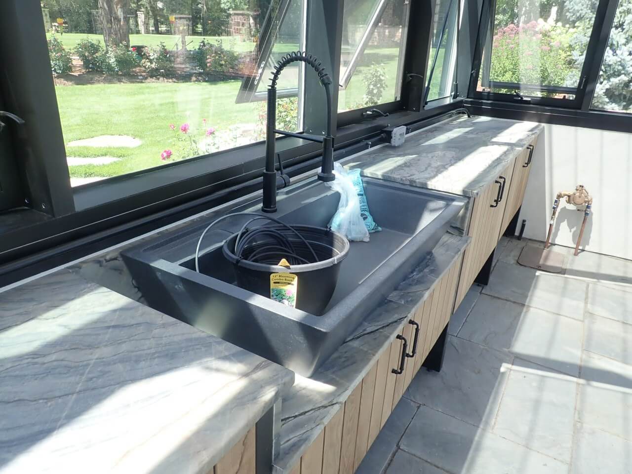 Custom greenhouse cabinetry with large wash basin sink
